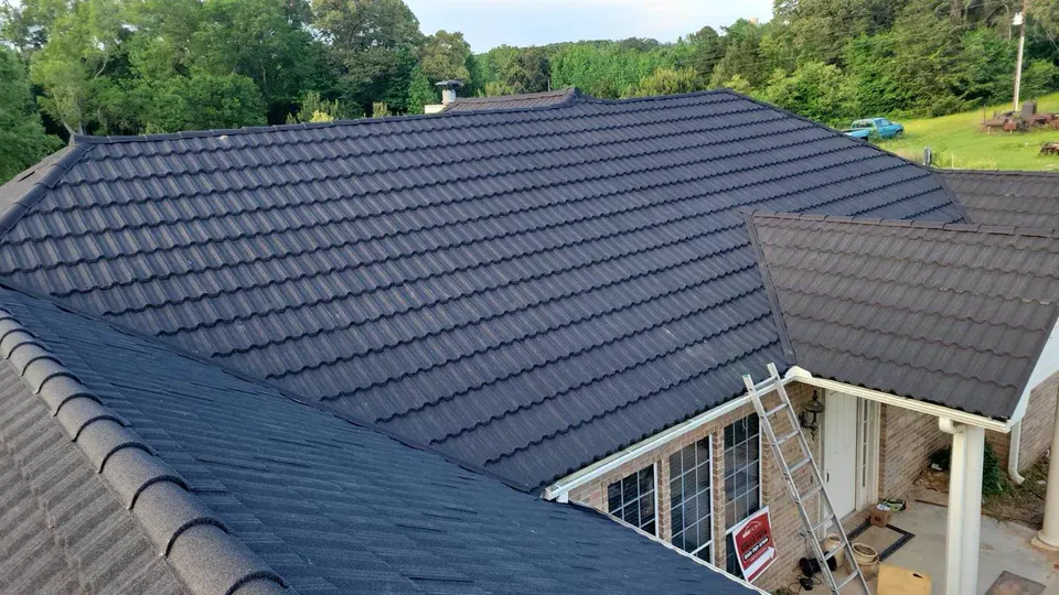 Dark stone-coated steel roof in a tile profile